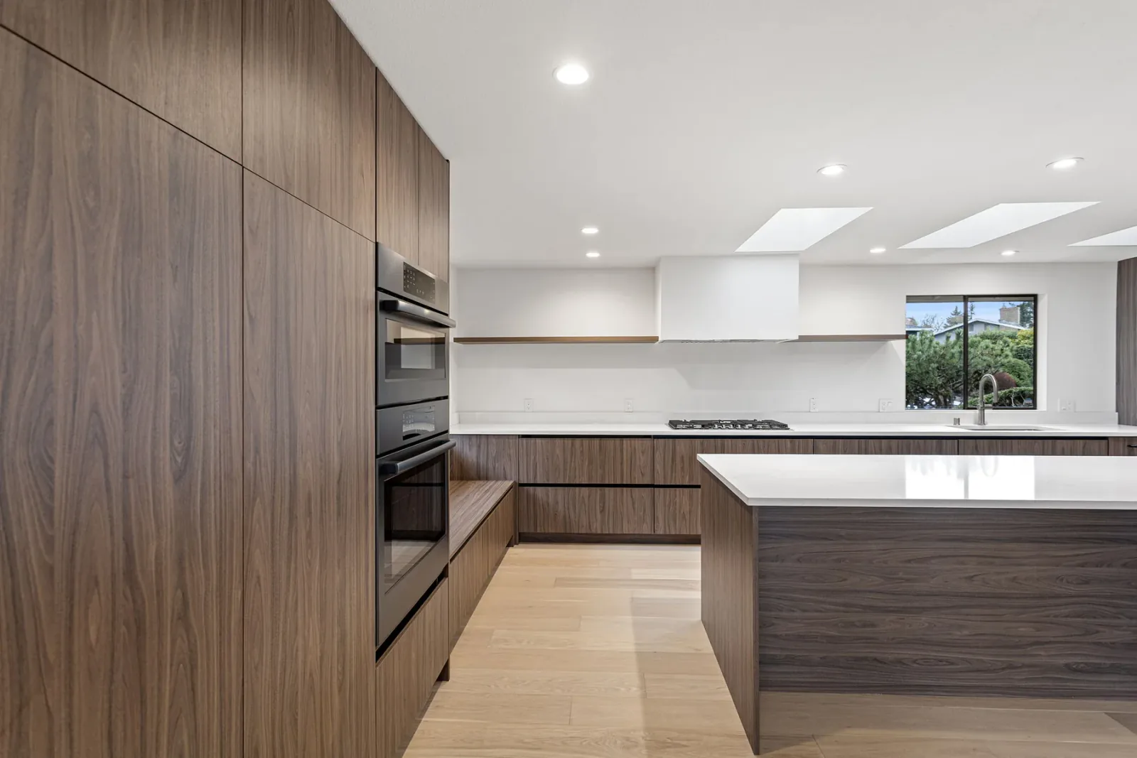 Finished Bellevue kitchen with flat-panel cabinetry and waterfall island