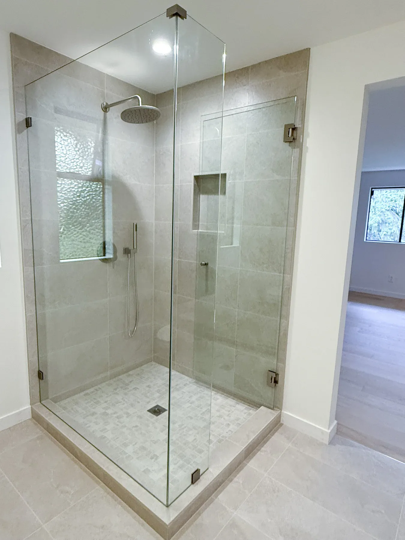 Frameless glass shower in the Bellevue primary bathroom