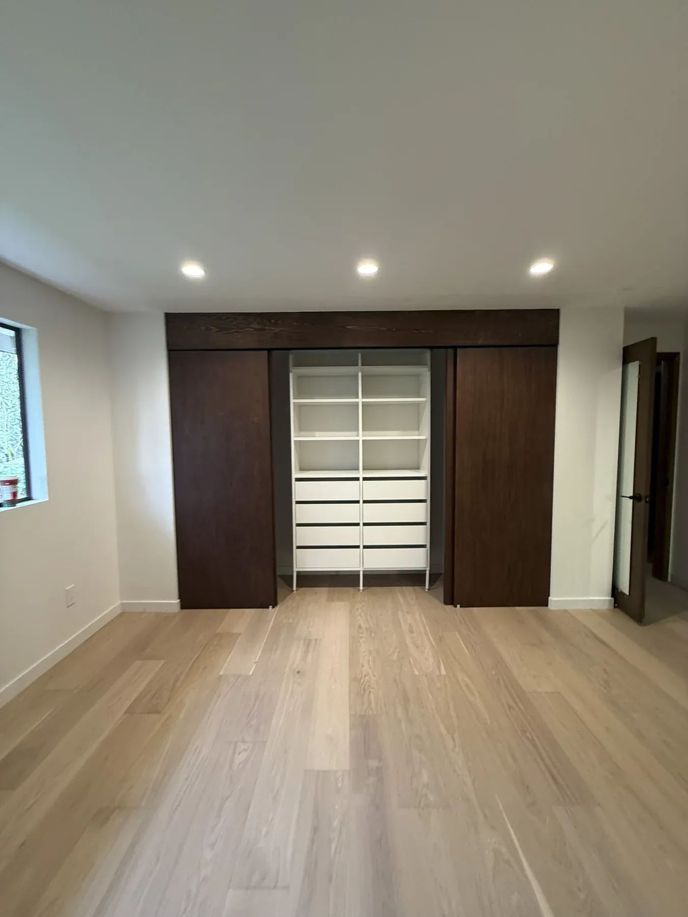 Finished primary bedroom and custom closet in the Bellevue remodel
