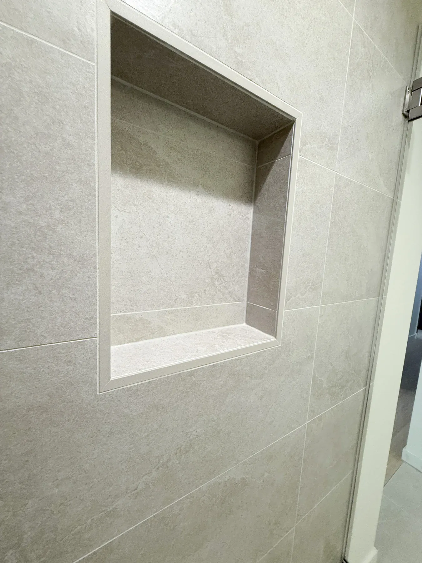 Recessed shower niche in the Bellevue primary bathroom