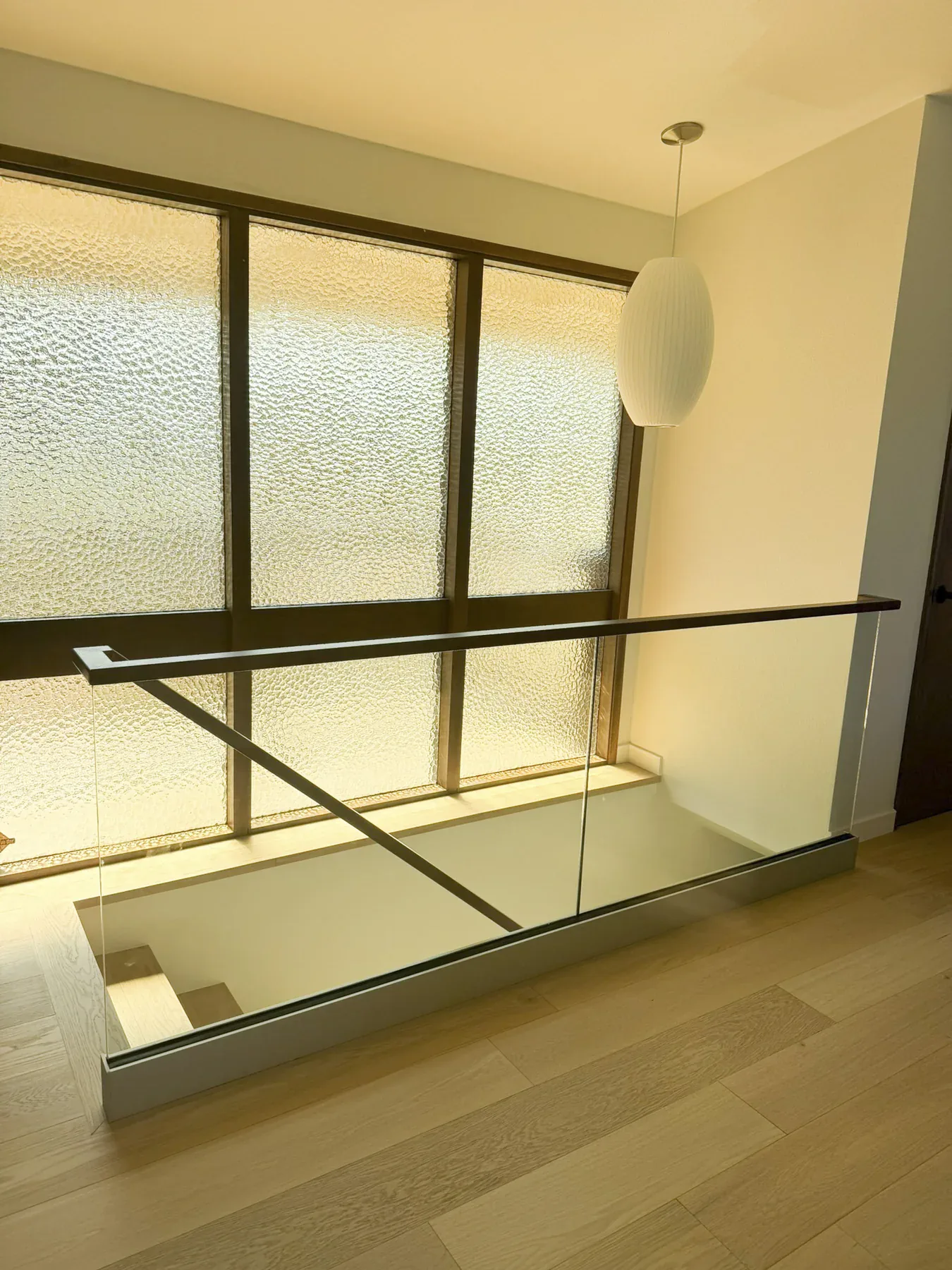 Finished Bellevue staircase railing and upper-level flooring