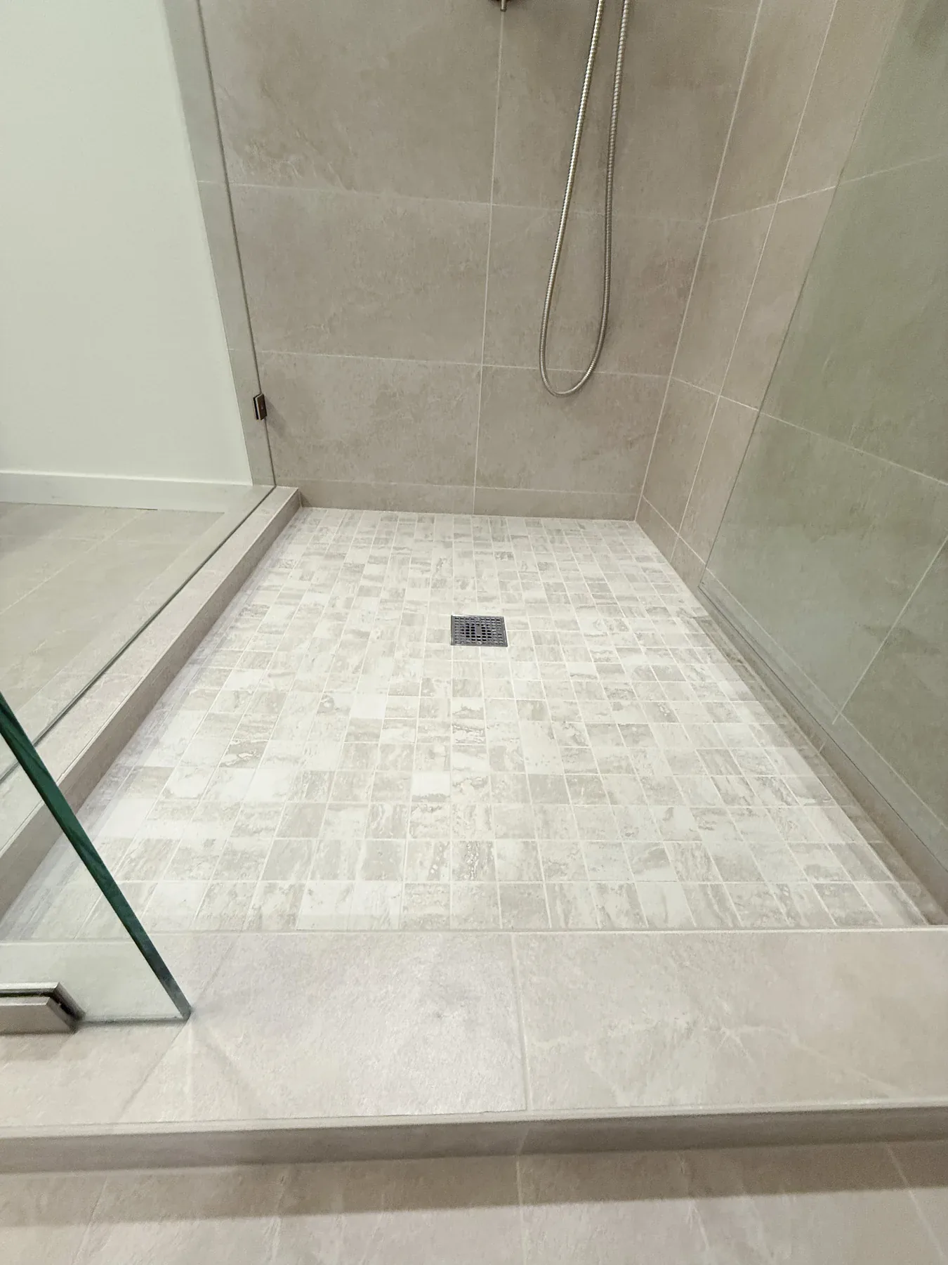 Tiled shower floor in the Bellevue primary bathroom