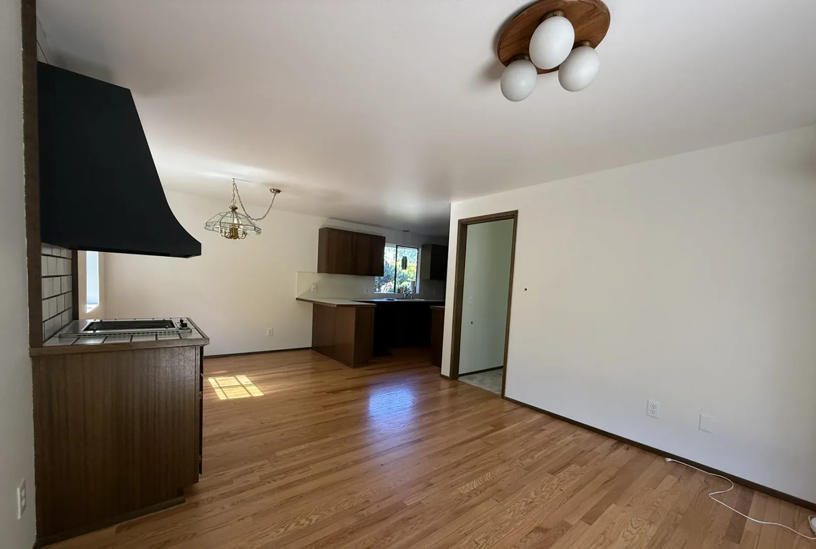 Before: original kitchen and living area in the Bellevue full home remodel