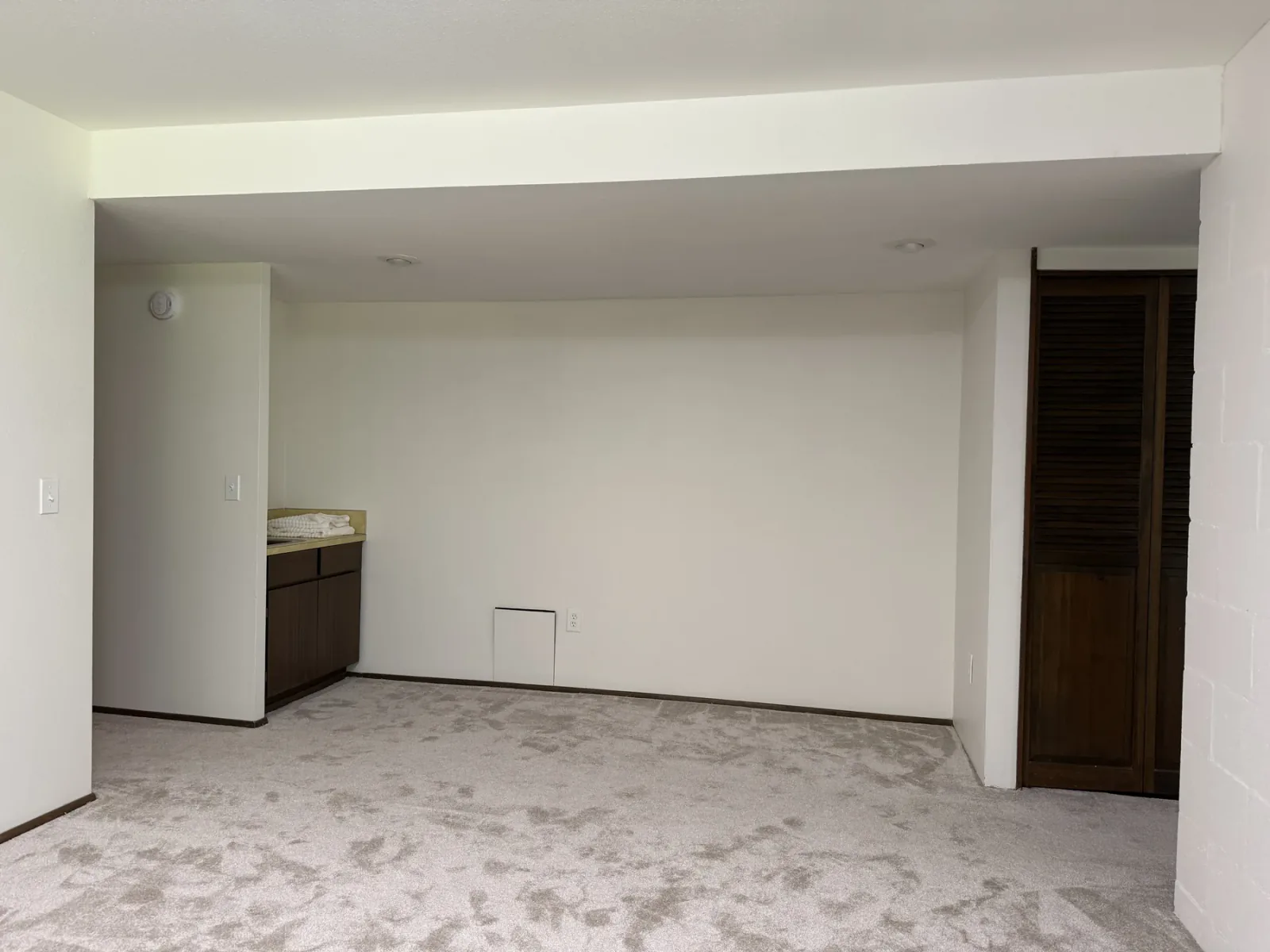 Old Bellevue lower-level room before remodeling