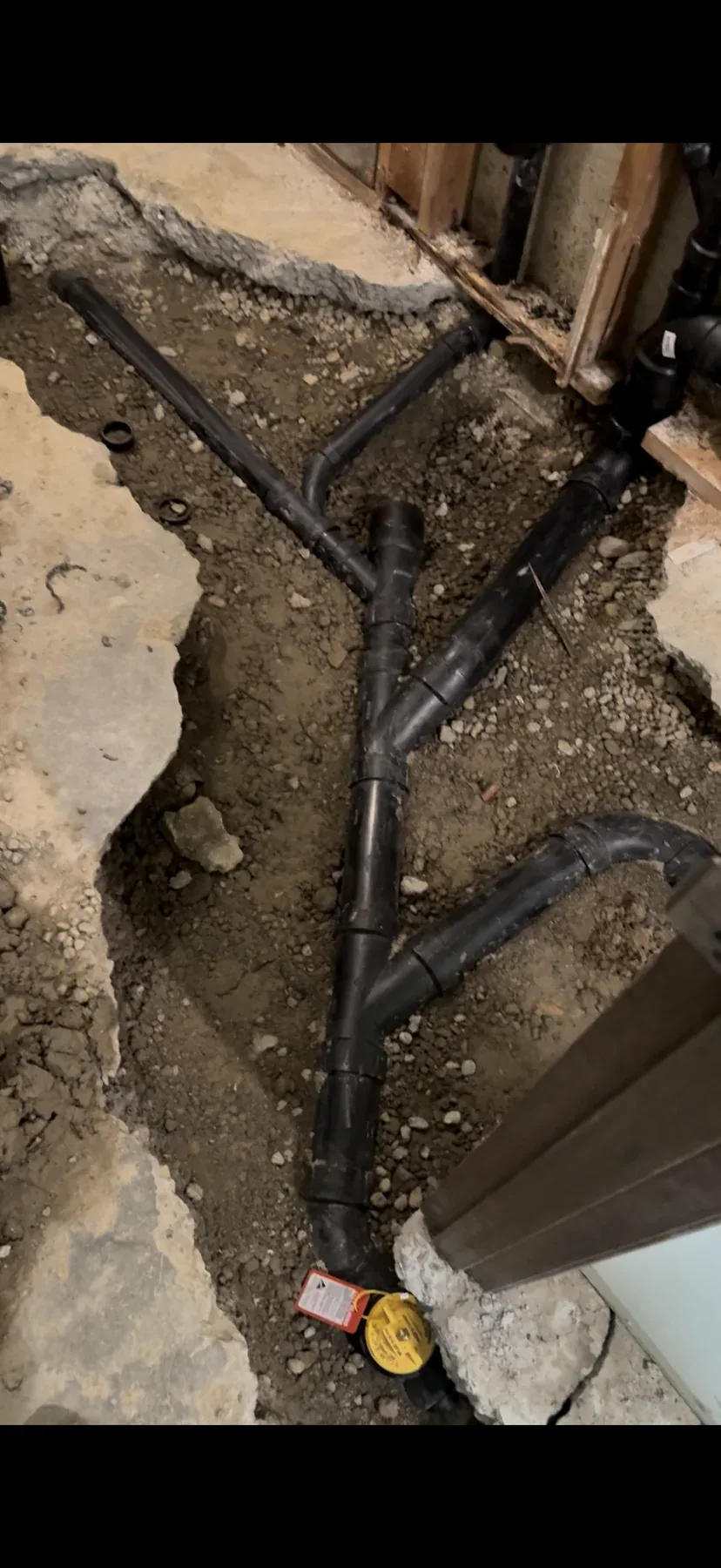 Lower-floor bathroom underground plumbing trench during the Bellevue remodel