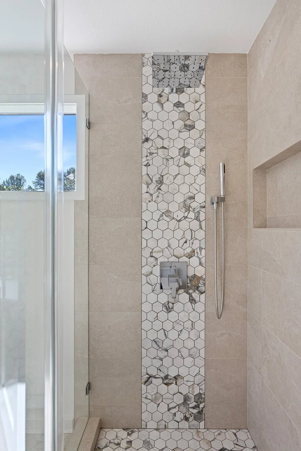 Floor-to-ceiling shower tile in the completed Primary Bathroom