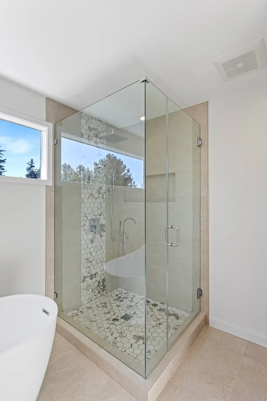 Frameless walk-in shower in the completed Primary Bathroom