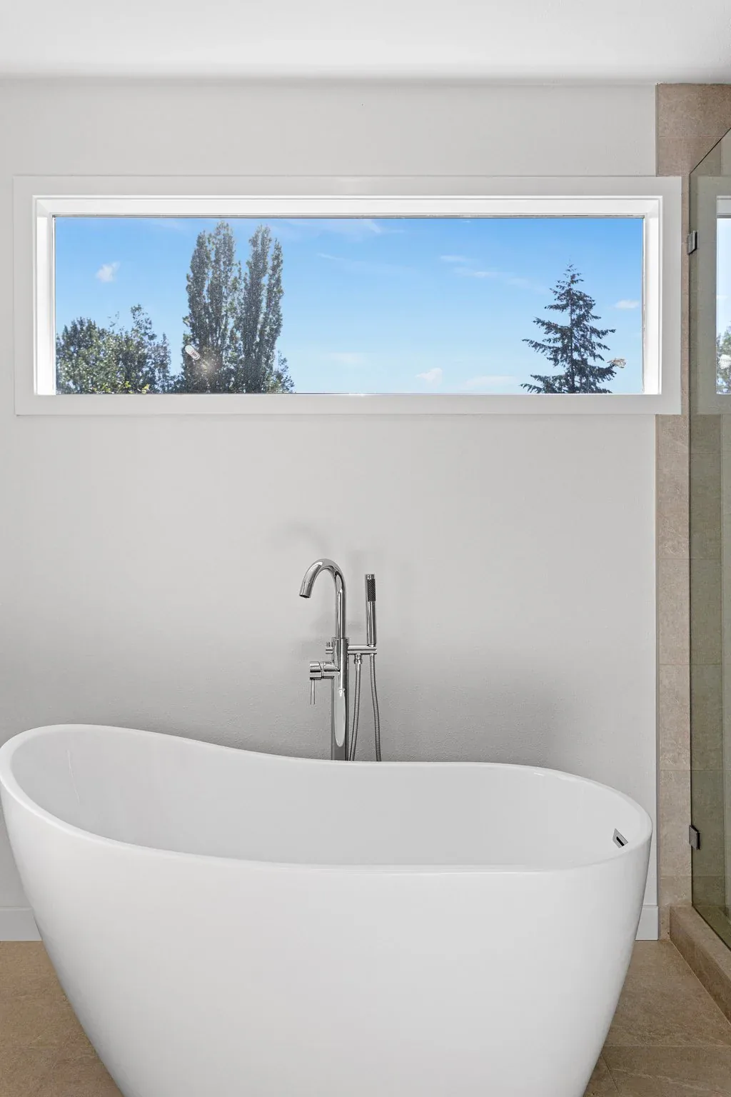 Freestanding soaking tub in the completed Primary Bathroom