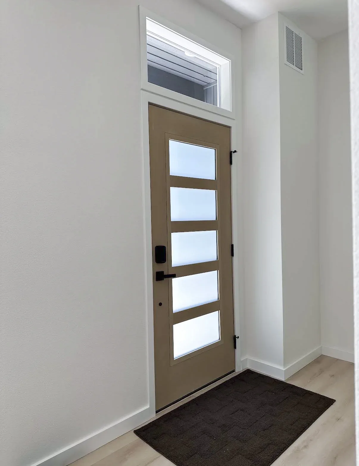 Frosted-glass front door in the completed Kirkland foyer