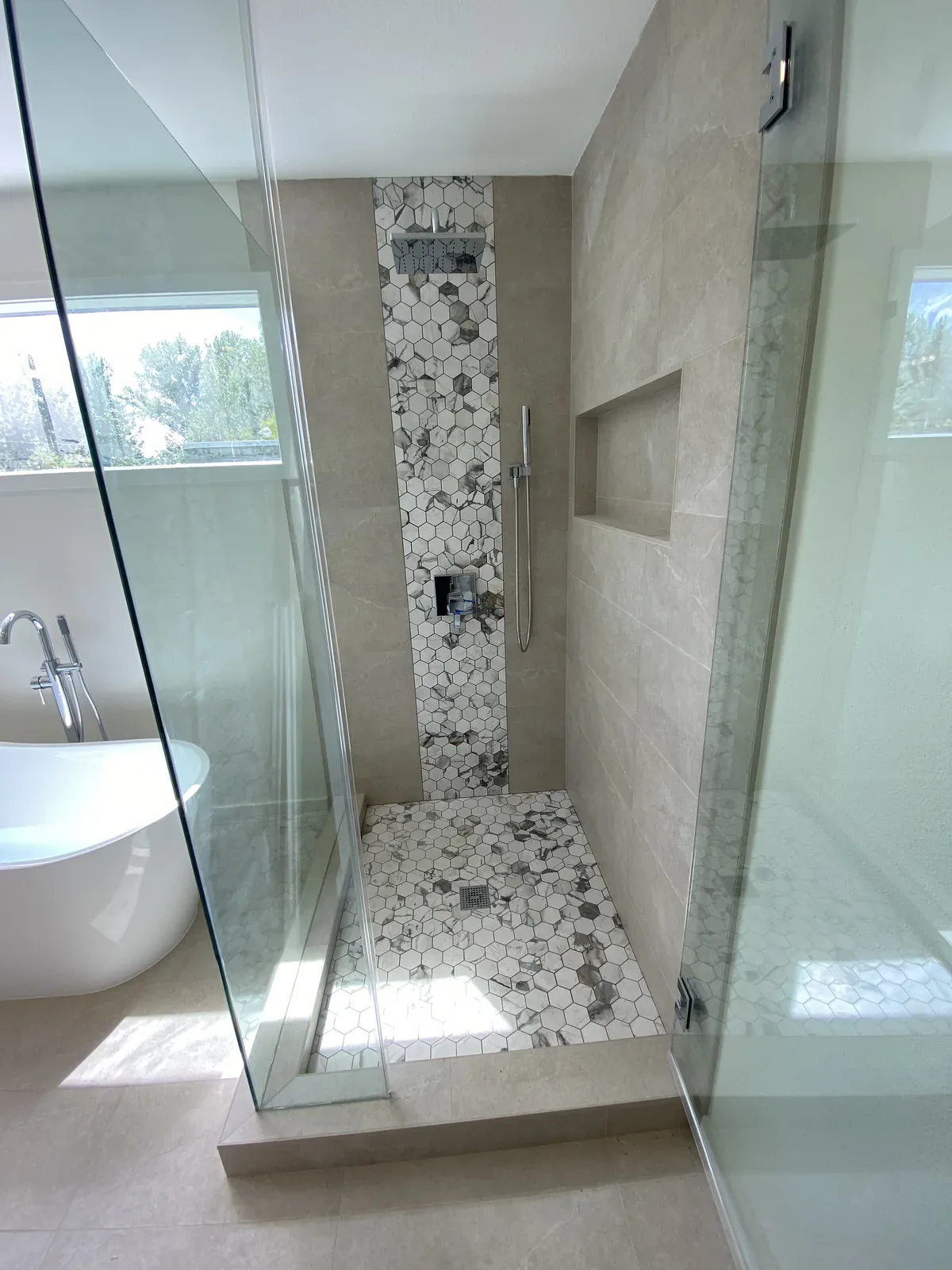 Glass and mosaic shower detail in the completed Primary Bathroom