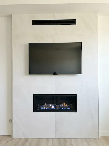 Modern main-floor gas fireplace after the remodel