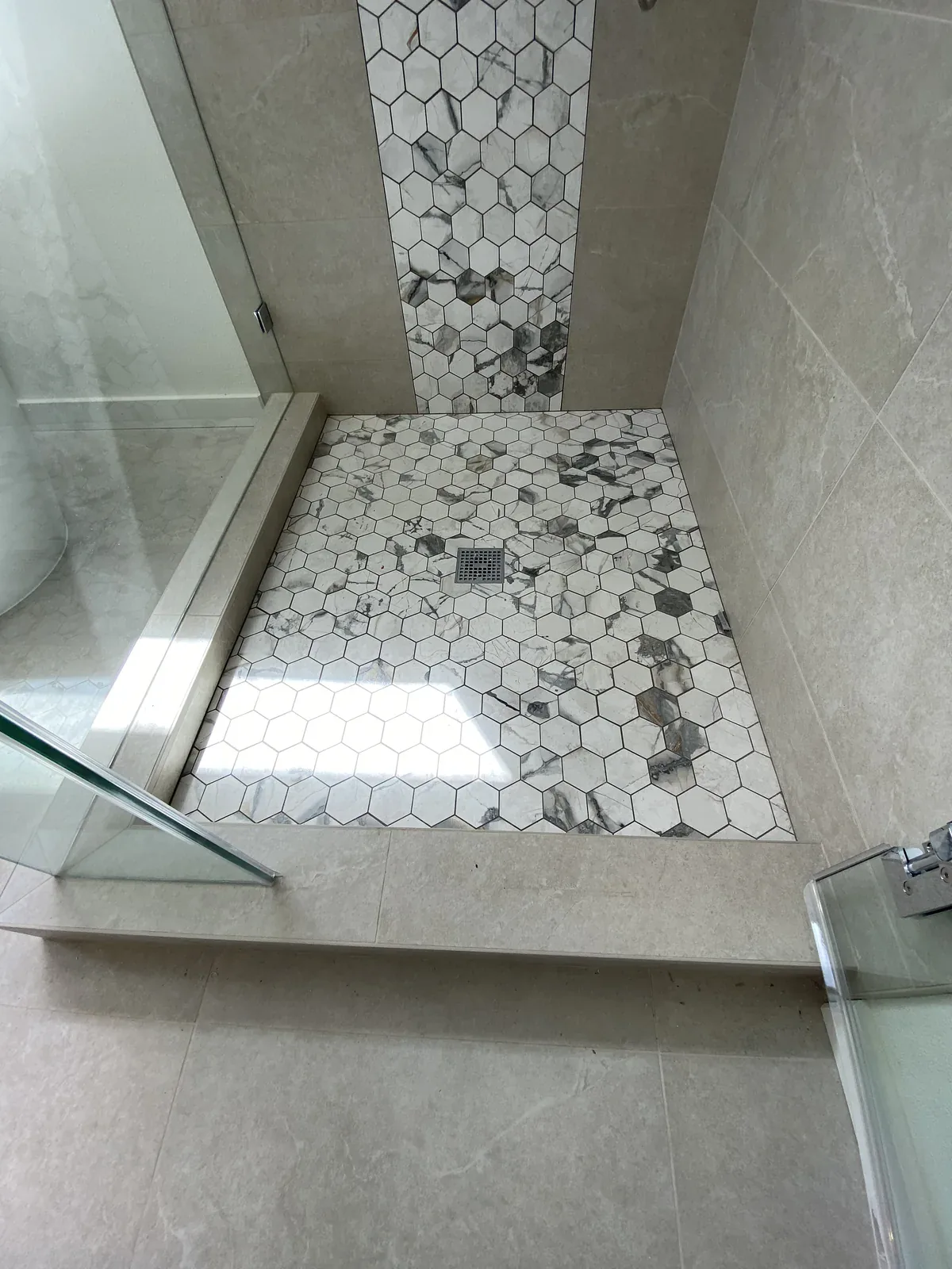 Mosaic shower floor in the completed Primary Bathroom