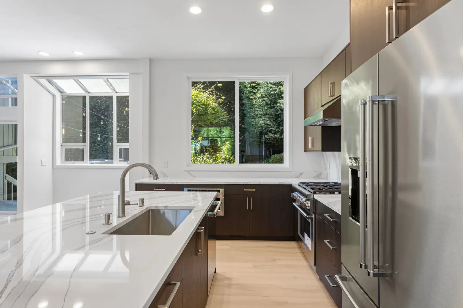 After: completed open-concept kitchen in the Kirkland full home remodel