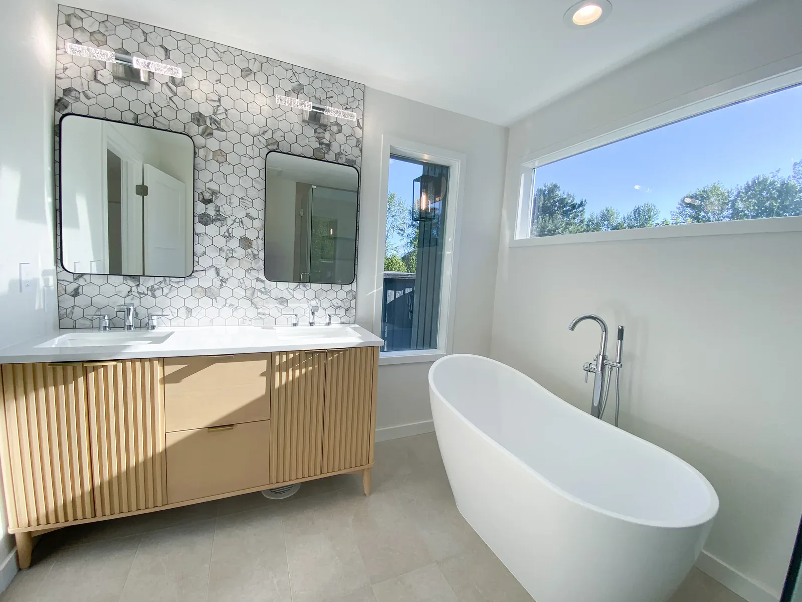 Vanity and soaking tub in the completed Primary Bathroom