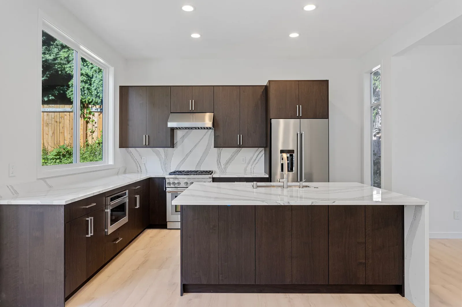 Waterfall-edge island in the finished Kirkland kitchen