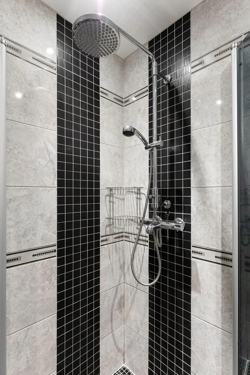 After: Kirkland bathroom remodel with modern black and white tile and curbless shower