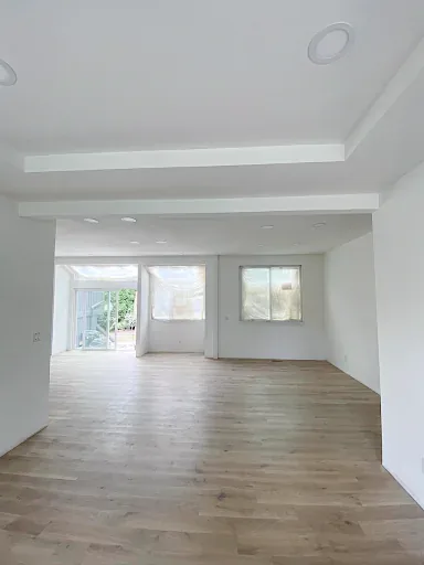 Open kitchen layout after structural, drywall, paint, and flooring work