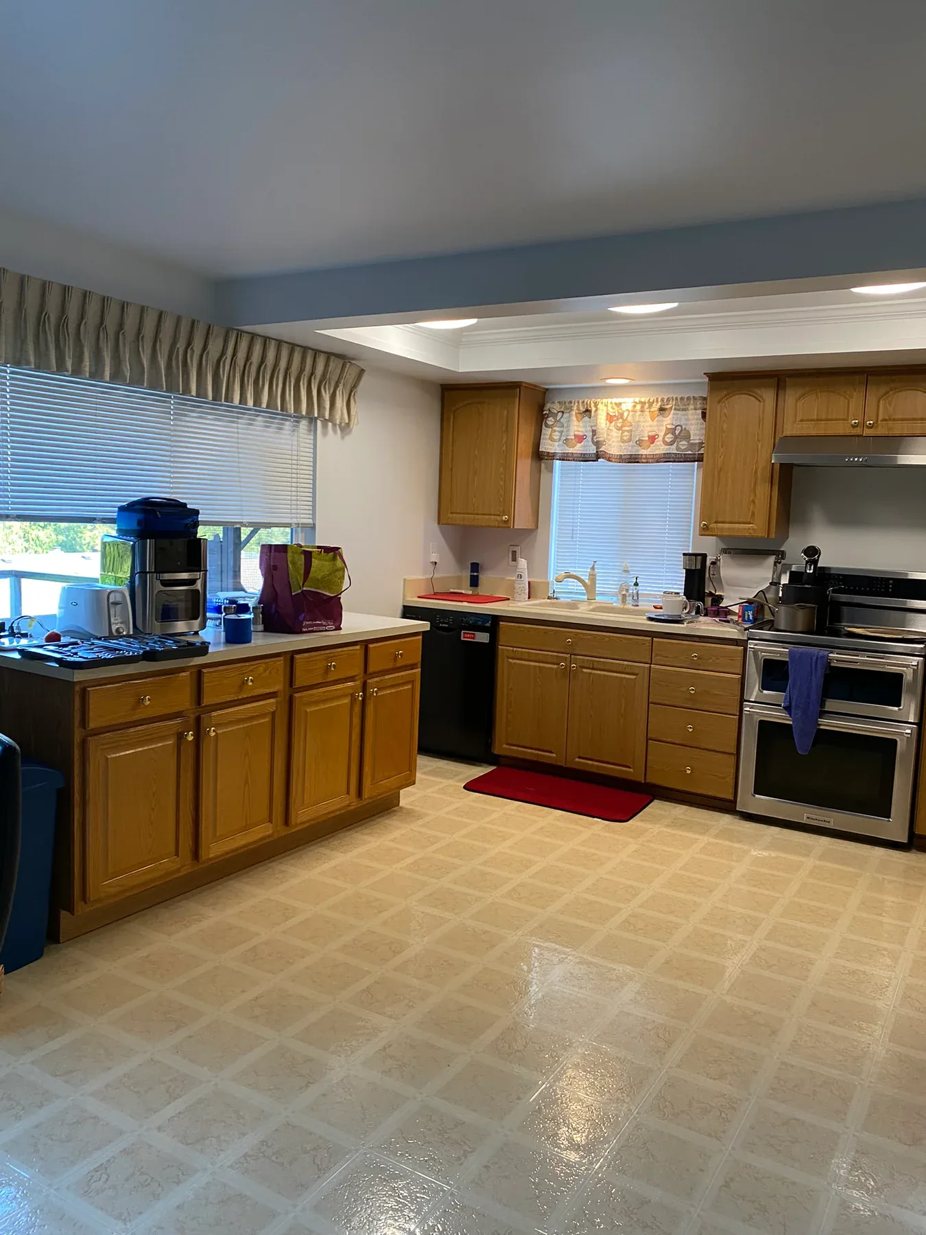 Old upper cabinets and cooking area before the Kirkland kitchen remodel