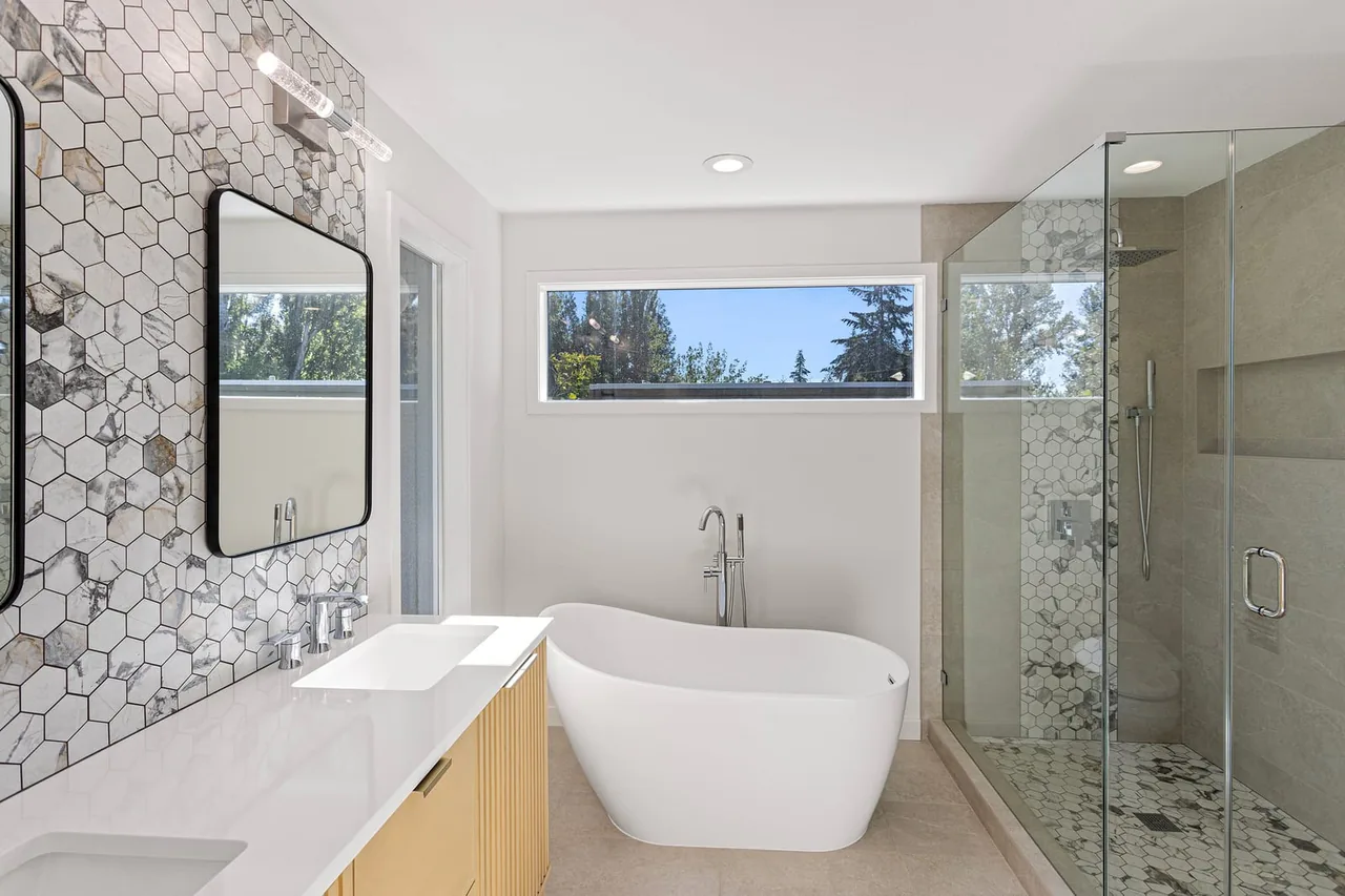 Bathroom remodel after with modern finishes and new fixtures by Luxe Remodeling LLC