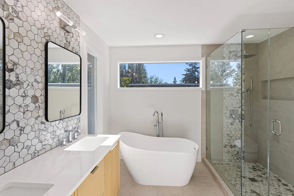 Bathroom remodel after with modern finishes and new fixtures by Luxe Remodeling