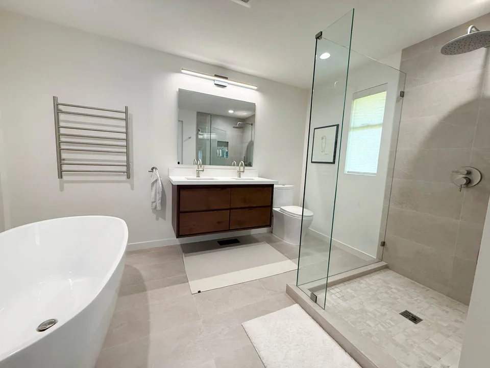 After: remodeled bathroom with modern custom closet and updated finishes